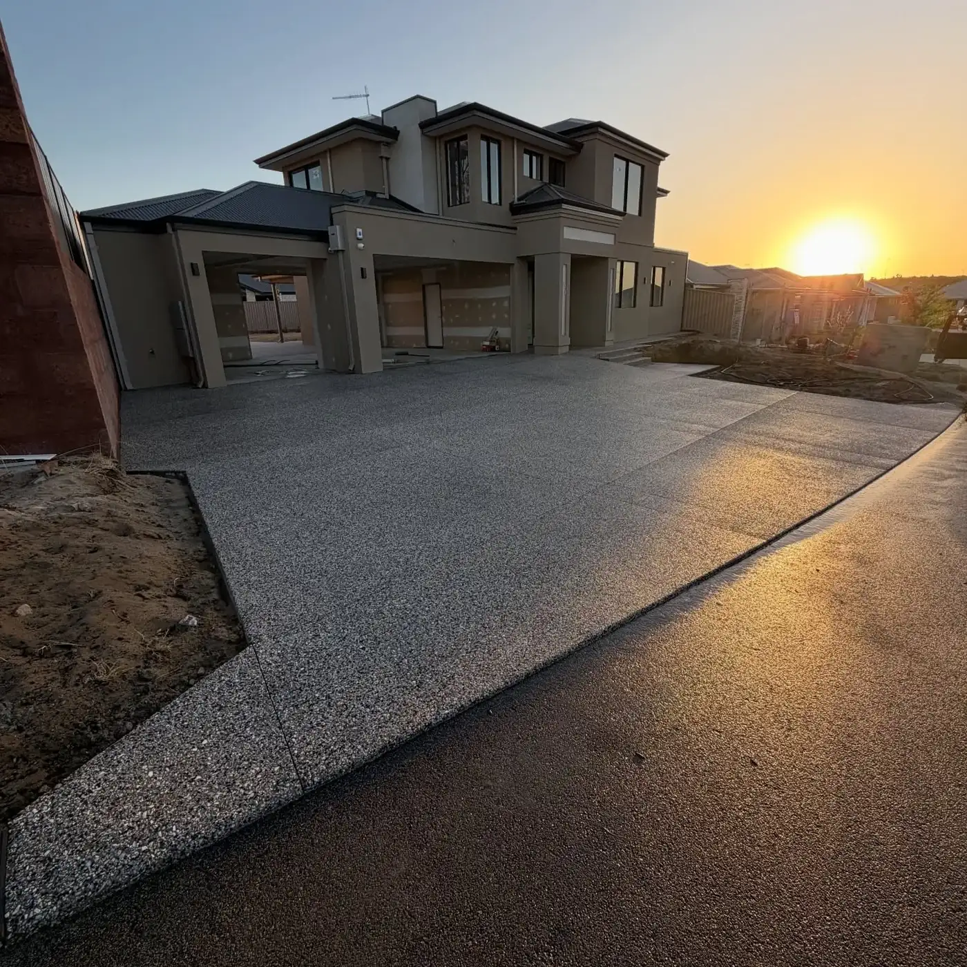 Fresh exposed aggregate house surround at dusk on a two-storey Perth home