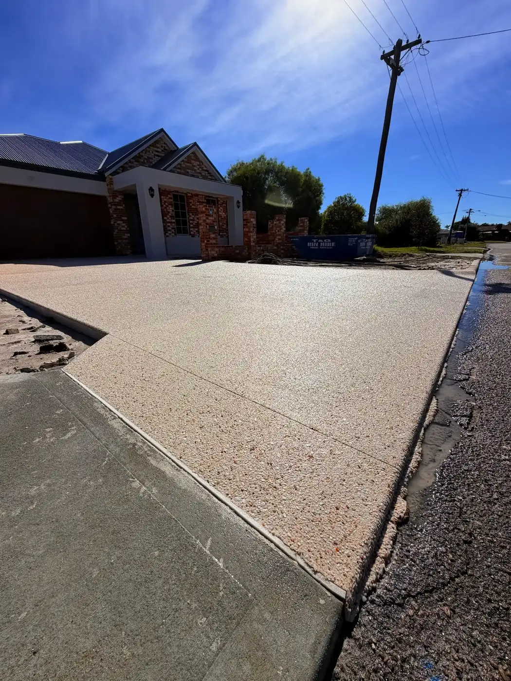 Pale exposed aggregate double driveway with a clean sawn edge, Perth