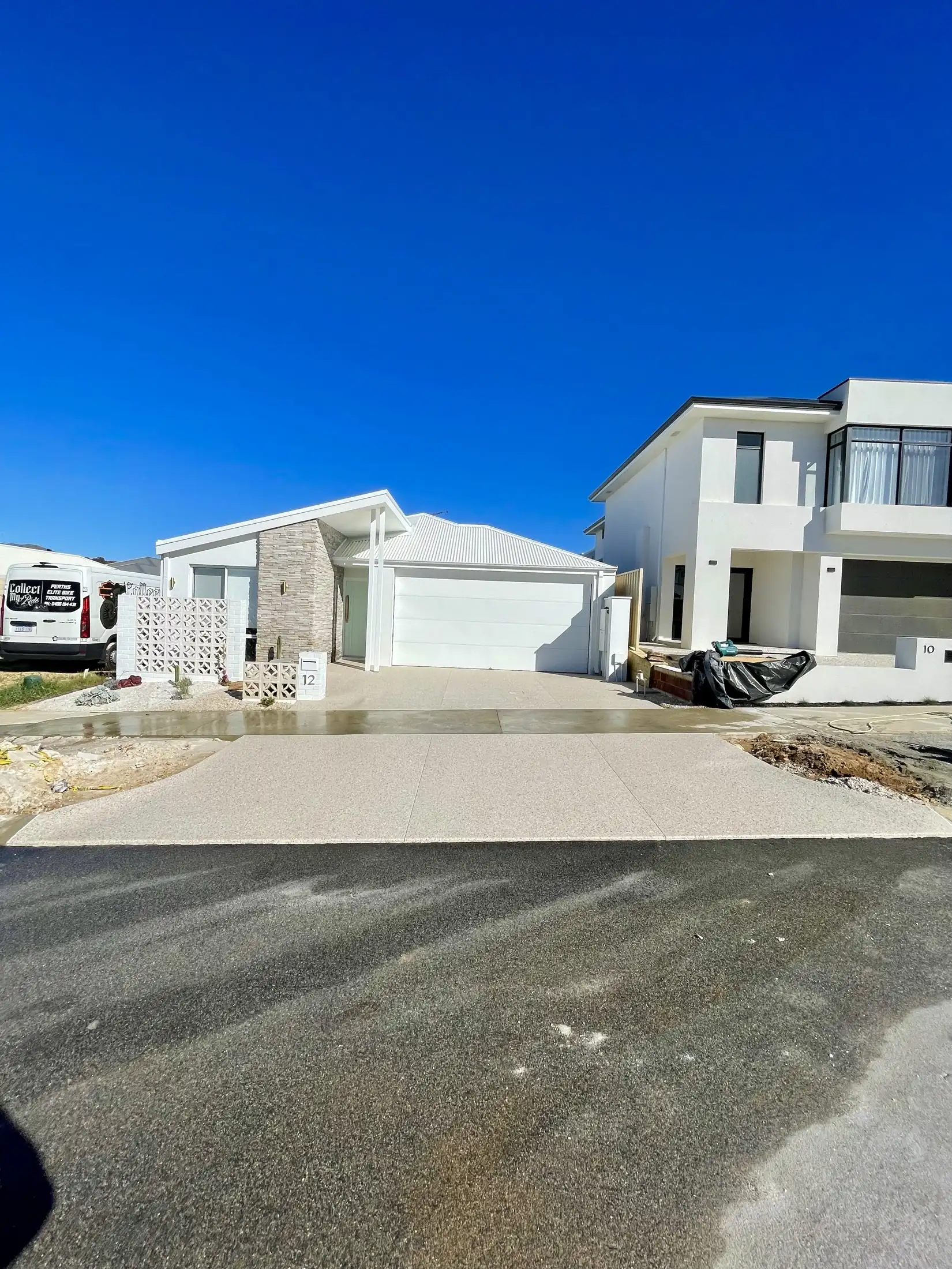 Concrete driveway meeting the street crossover at a Perth home
