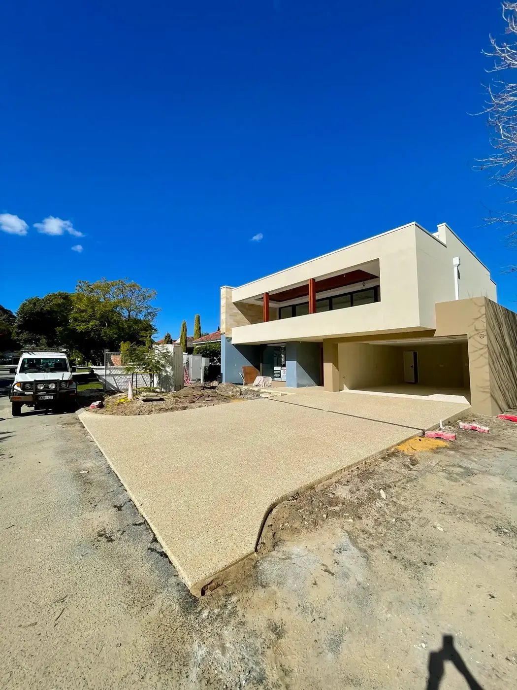 New exposed aggregate driveway poured over sand at a new-build Perth home