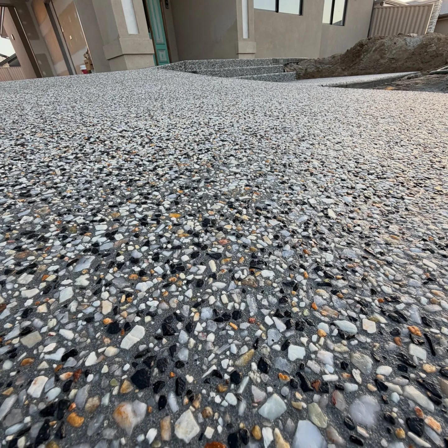 Exposed aggregate concrete close-up showing stone blend, Perth