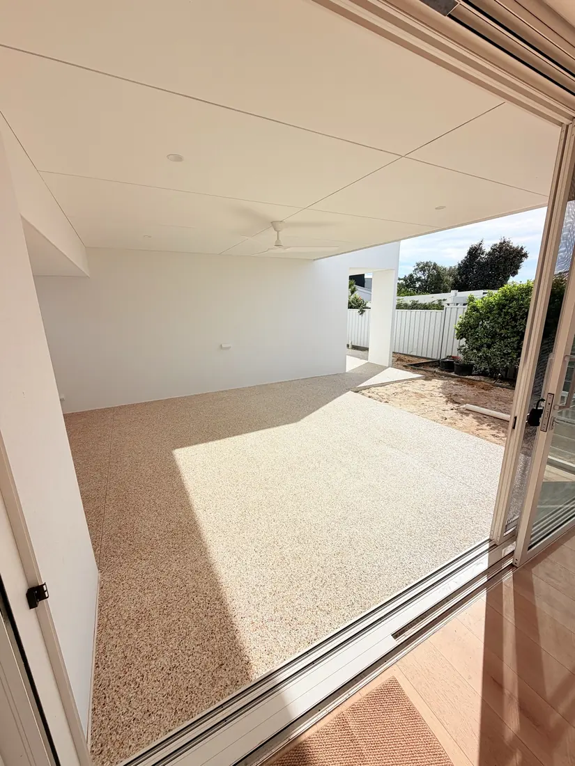 Light exposed aggregate alfresco patio poured under the roofline of a Perth home