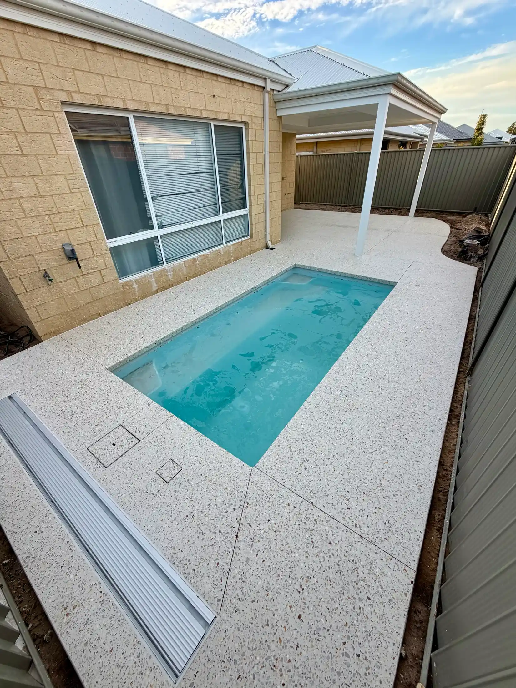 Flush exposed aggregate pool surround with a linear drain, Perth