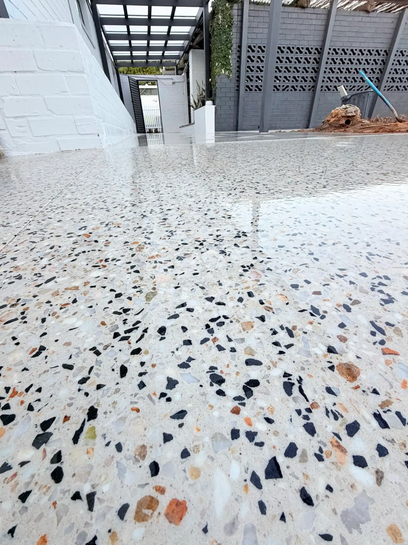 Honed concrete with large exposed pebbles ground to a terrazzo-look finish