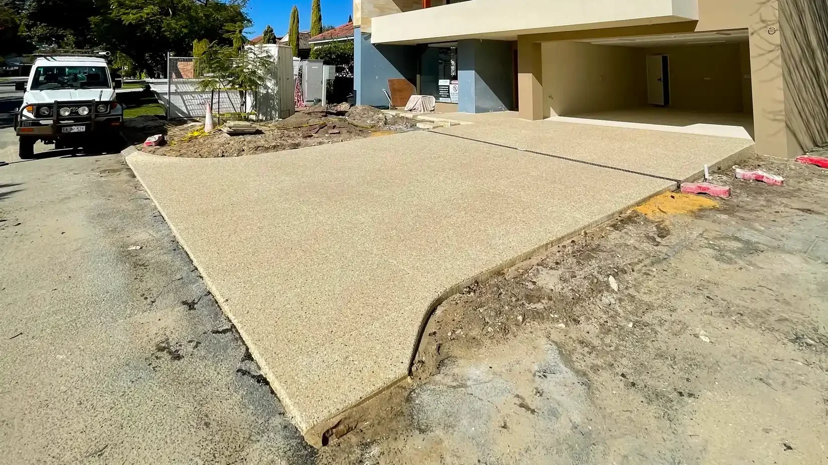 Light exposed aggregate driveway leading to a modern two-storey Perth home