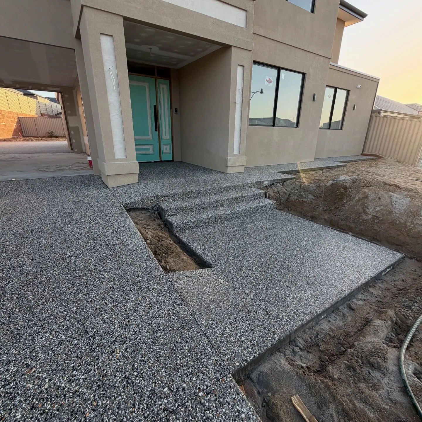 Exposed aggregate path and steps poured against a Perth home by Only Concrete